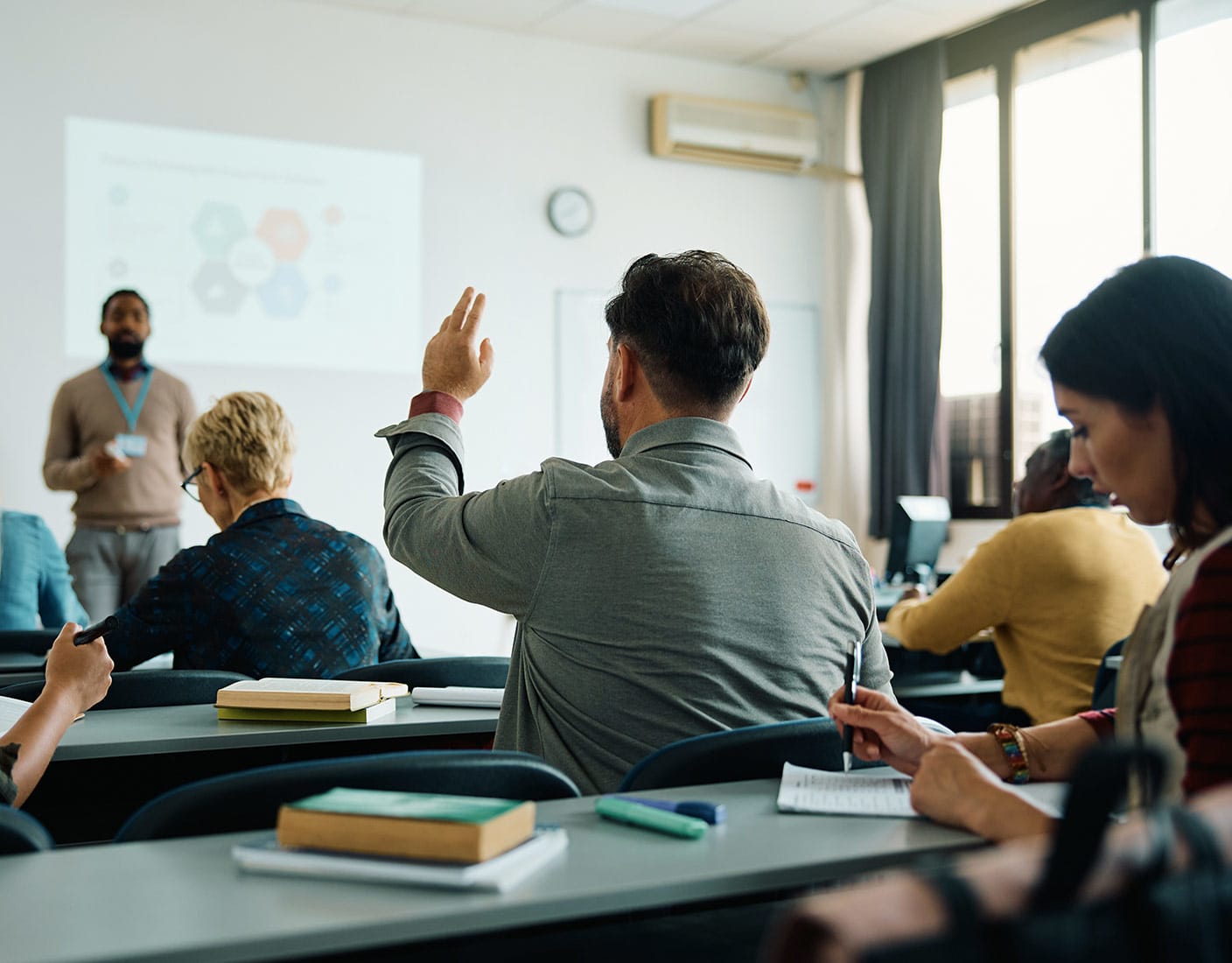 A group of students seated at desks, engaged in learning within a classroom setting.